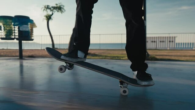 Skateboarding on Street. Cinematic close up of authentic and trendy skateboarder stroll through sunset filled california vibes promenade on warm summer evening. Outdoors activity