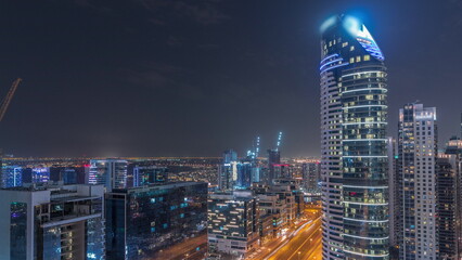 Dubai's business bay towers aerial night timelapse. Rooftop view of some skyscrapers