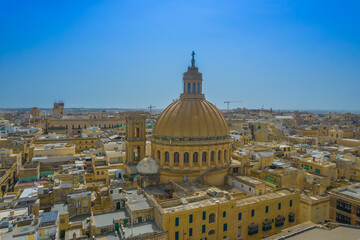 Aerial view of Basilica Lady of Mount Carmel church, St. Paul's Cathedral in the old town of Valetta, Malta. Roofs of Malta capital from above on a sunny day