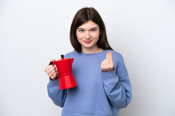 Young Russian woman holding coffee pot isolated on white background making money gesture