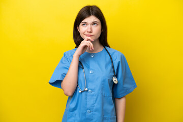 Young surgeon doctor Russian woman isolated on yellow background having doubts and thinking