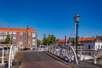 Fototapeta na wymiar Beautiful old ancient bridge on the canal in Middelburg on a sunny summer day