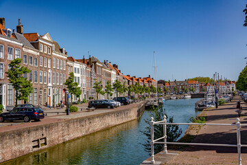 Obraz premium Sunny summer day by the water canal in Middelburg, facing the row of a building facades
