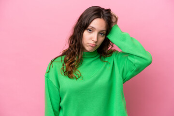 Fototapeta premium Young caucasian woman isolated on pink background with an expression of frustration and not understanding