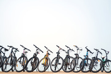 Row of bikes on the beach with misty sky background