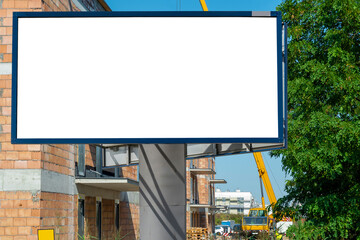 Fototapeta premium Blank white advertising billboard in front of the construction site
