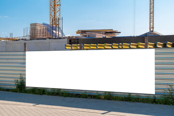 Blank white advertising banner on the construction site fence