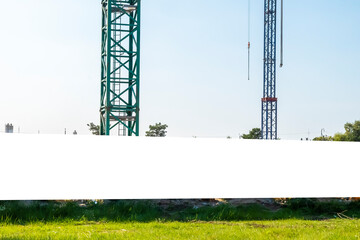 Blank white advertising banner on the fence of construction site