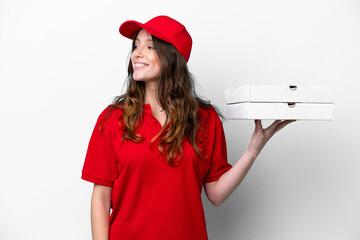 Pizza delivery woman with work uniform picking up pizza boxes isolated on white background looking...