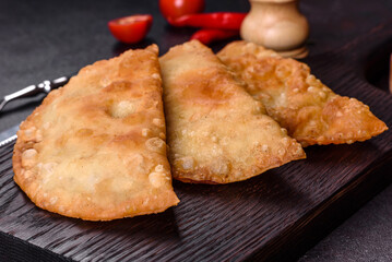Homemade chebureks filled with minced meat and onions, traditional Caucasian cuisine