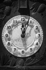 Old clock mechanism, black and white. Retro clock arrows and numbers. Time measure. New year concept. The past epoch. Hour and minute arrows. Dirty ancient clock in dust. Old clock face.