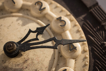 Old clock mechanism. Retro clock arrows and numbers. Time measure. Ancient watch, close up. The...