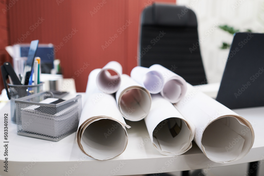 Poster Close-up of blueprints of construction projects on table of architect at office