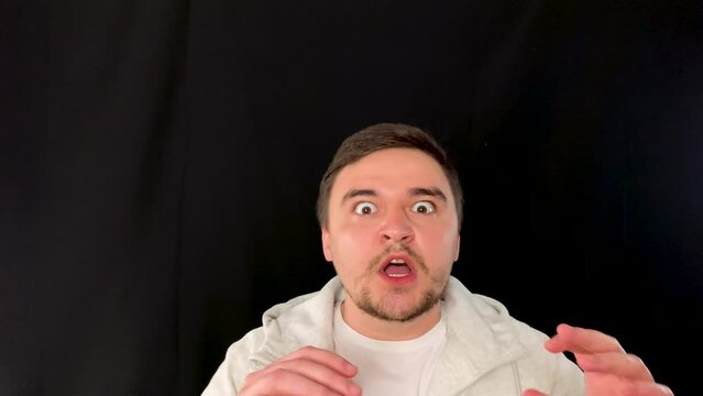 Terrified young adult fears for his life, expression of fear and absolute horror