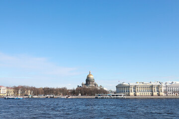 Fototapeta na wymiar View of St. Isaac's Cathedral across the Neva River on a sunny day