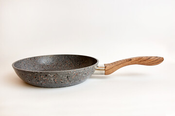 Quality frying pan made of cast iron alloy on a white background.