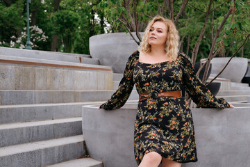adult beautiful girl model plus size xl in feminine dress floral print retro outdoor portrait