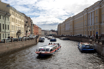 Russia, St. Petersburg - May 1, 2022: View of the embankment of the Moika River, a string of walking boats.