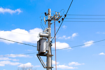 High Electric voltage wires and pole power lines,electric towers,power transformer against vibrant...