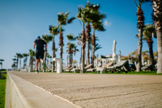 man jogging on tropical seafront