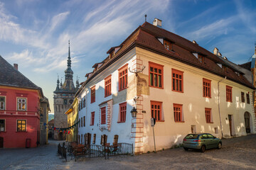 Fototapeta na wymiar Scenic view of historical Stag house and Clock Tower in the center of old town of Sighisoara, Transylvania, Romania