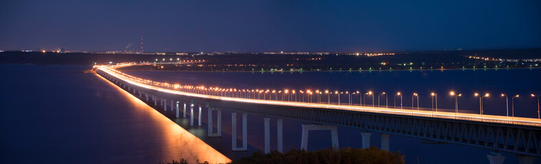 Fototapeta na wymiar Panorama of The Bridge in night time with illumination. The Presidential Bridge in Ulyanovsk, Russia