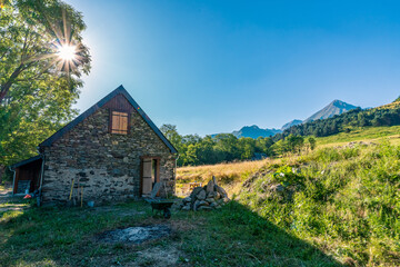 Plakat Authentic renovated Pyrenean barn in the Aure valley. slate roof, exposed stone and wood construction. amazing view on the mountains