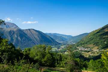 view of valley Aure in the french pyrenees mountains on a cloudy day with typical pyrenean village in altitude