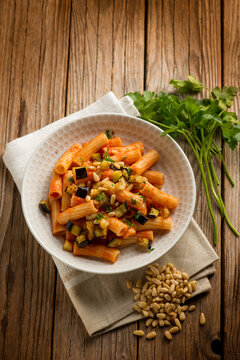 pasta with eggplants pine nuts tomato and parsley