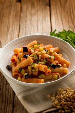 pasta with eggplants pine nuts tomato and parsley