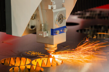 Automatic cnc laser cutting machine working with sheet metal with many sparks at factory, plant....