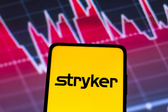 May 4, 2022, Brazil. In this photo illustration the Stryker Corporation logo seen displayed on a smartphone screen, with graphic representation of the stock market in the background.