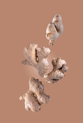 ginger roots on beige background, flying food