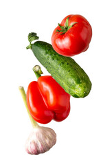 garlic, tomato, cucumber, pepper fly on a white background, close-up