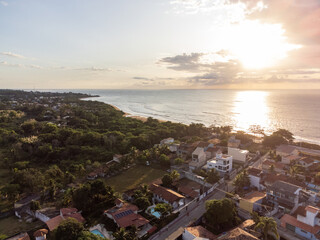 Fototapeta na wymiar beautiful seaside city of Brazil with dark sand and sunrise on the atlantic ocean - Bicanga, Espirito Santo - aerial drone view