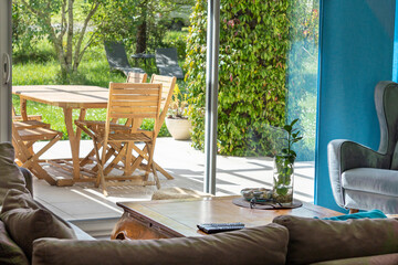 View from the living room onto the terrace, through the bay window, on a beautiful sunny spring day