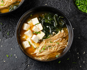 Rich miso soup with enoki mushrooms, wakame seaweed and tofu, vegetarian, vegan Asian food.