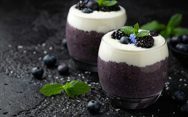 Healthy vanilla blueberry chia pudding in a glass with fresh berries