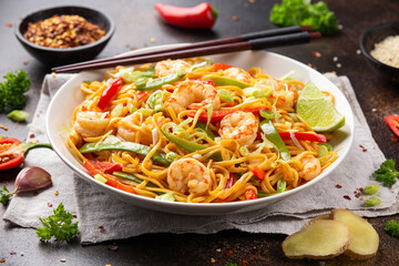 Stir fry noodles with prawns and vegetables in white plate. Healthy asian food