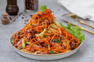 Grated marinated carrot salad with salami, cucumber and croutons, tossed together in a homemade...