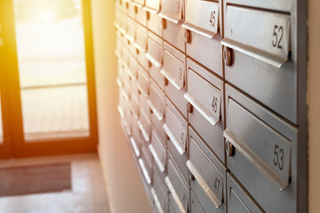 Close-up of metal mailboxes near the entrance in modern apartment building