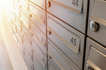 Close-up of metal mailboxes near the entrance in modern apartment building - Powered by Adobe