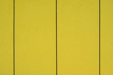 Closeup of yellow wall with visible surface texture