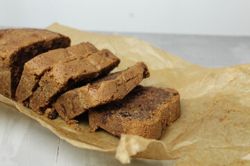 a cupcake cut into portions lies on paper. Cooking homemade cakes