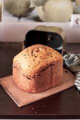 Freshly baked bread from the bread machine on the kitchen table. Homemade baking