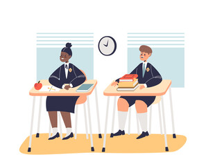 Schoolchildren in uniform sitting at school desk in classroom at lesson. School pupils in class