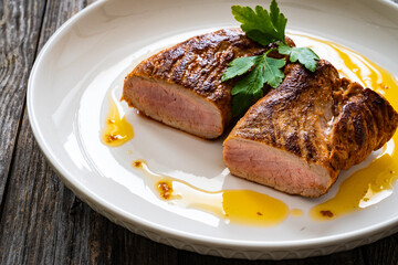 Roasted pork loin on wooden table
