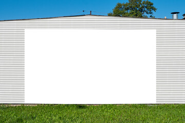 Blank white advertising billboard mounted on the wall of the building