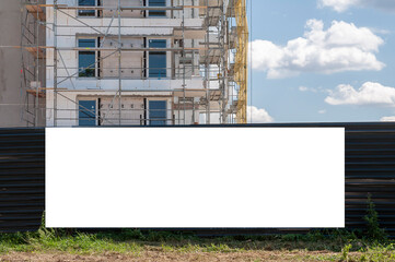 Blank white banner for advertisement on the fence of construciton site