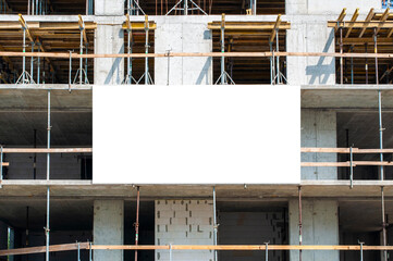 Blank white banner for advertisement on the facade of building under construction